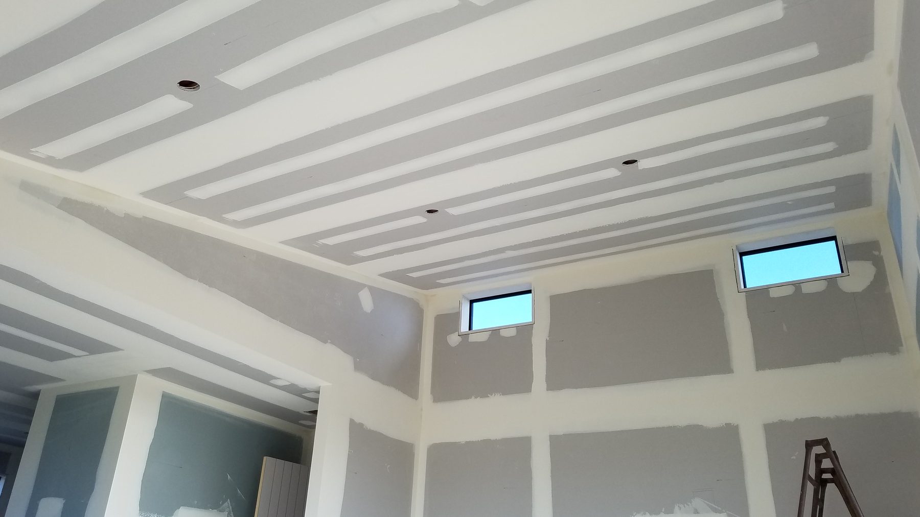 Freshly stopped plasterboard ceiling and walls, sanded smooth and ready to paint